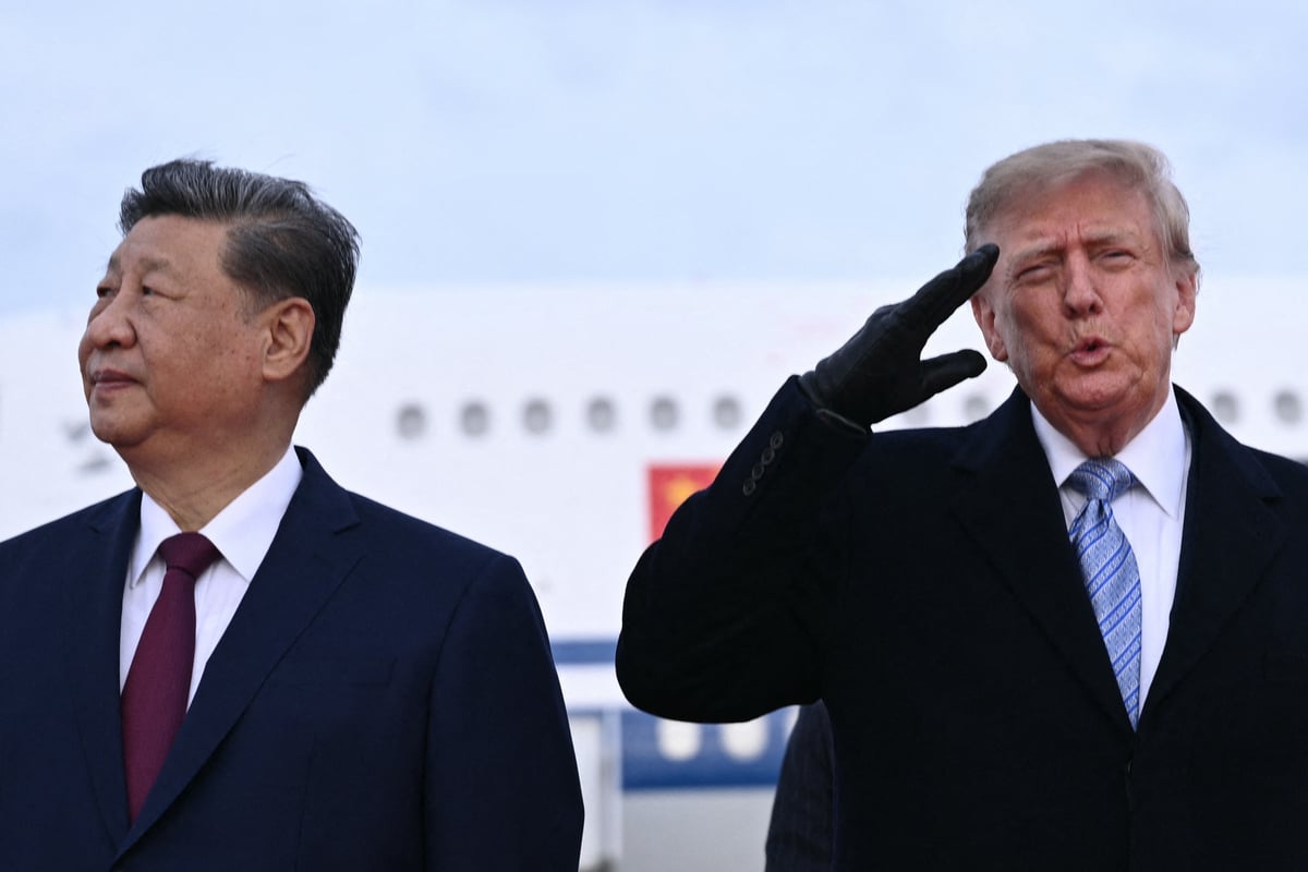 Trump accused of using AI to edit out wince from jet flyover in photo with Xi