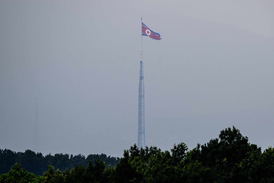 A North Korean flag is seen fluttering at the village of Gijungdong in North Korea.