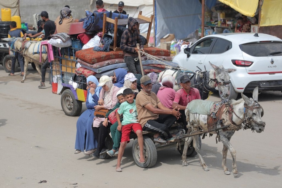 Palestinians fleeing unsafe areas in Rafah arrive with their belongings on a donkey cart in Khan Younis.
