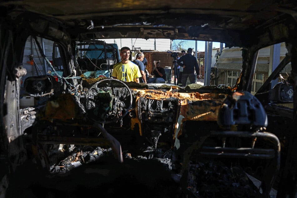 A Palestinian man inspects a car that was damaged during a late-night attack by Israeli settlers in the Israeli-occupied West Bank on September 27, 2026. Israel's far-right finance minister Bezalel Smotrich called for Israeli forces to "go to war" against Palestinians in the West Bank.