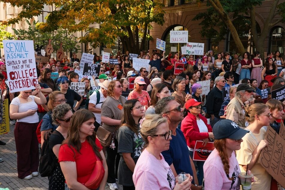 Protesters listen to speakers at a rally in support of a former Cornell University student known as Jane Doe at the Ithaca Commons on October 13, 2026 in Ithaca, New York.