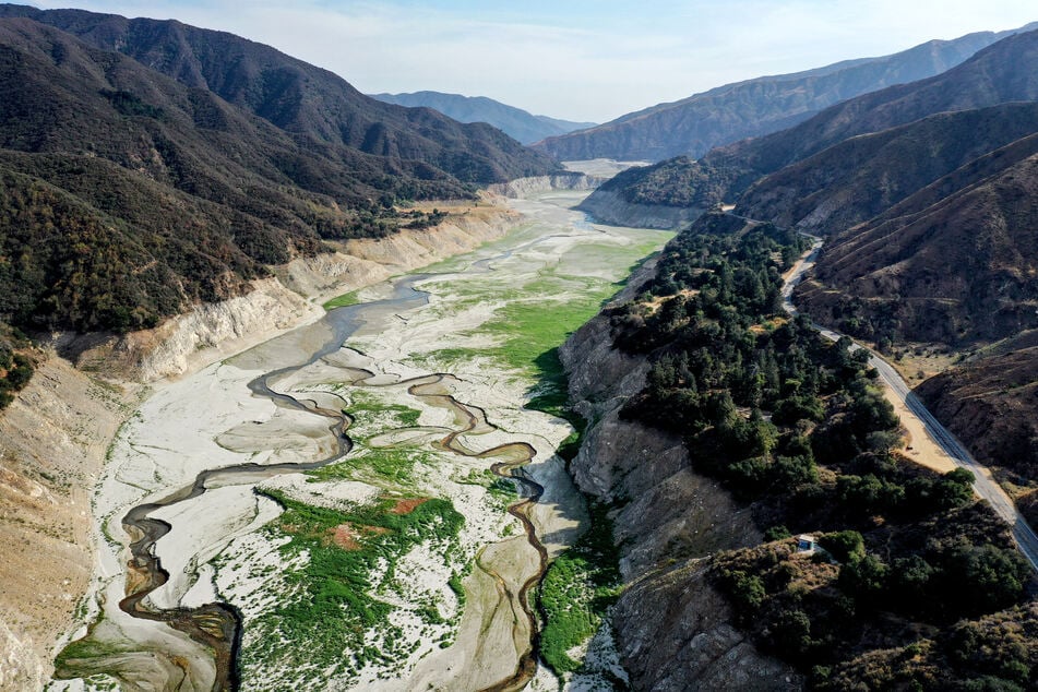 A woman survived a 200-foot fall while hiking on a trail in the San Gabriel Mountains.