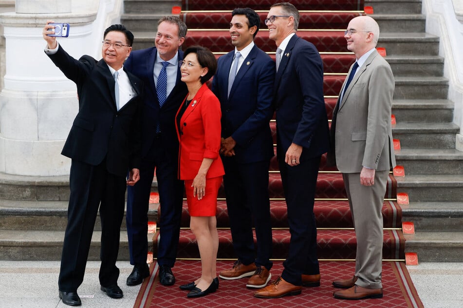 Taiwan National Security Council Secretary-General Joseph Wu takes a selfie with members of a bipartisan US congressional delegation, including Representatives Michael Cloud, Young Kim, Suhas Subramanyam, and Randy Feenstra, at the Presidential Office in Taipei on July 31, 2026.