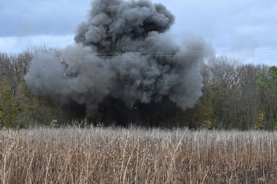 Deminers of Ukrainian national police explode mines found in a field in Izyum district, Kharkiv region on October 24, 2023, amid the Russian invasion of Ukraine.