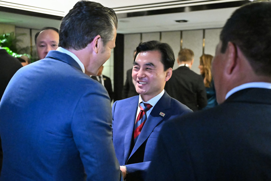 Pete Hegseth (l.) shakes hands with South Korea's Minister of National Defense Ahn Gyu-back as they arrive for a ministerial roundtable during the 23rd Shangri-La Dialogue summit in Singapore on May 30, 2026.