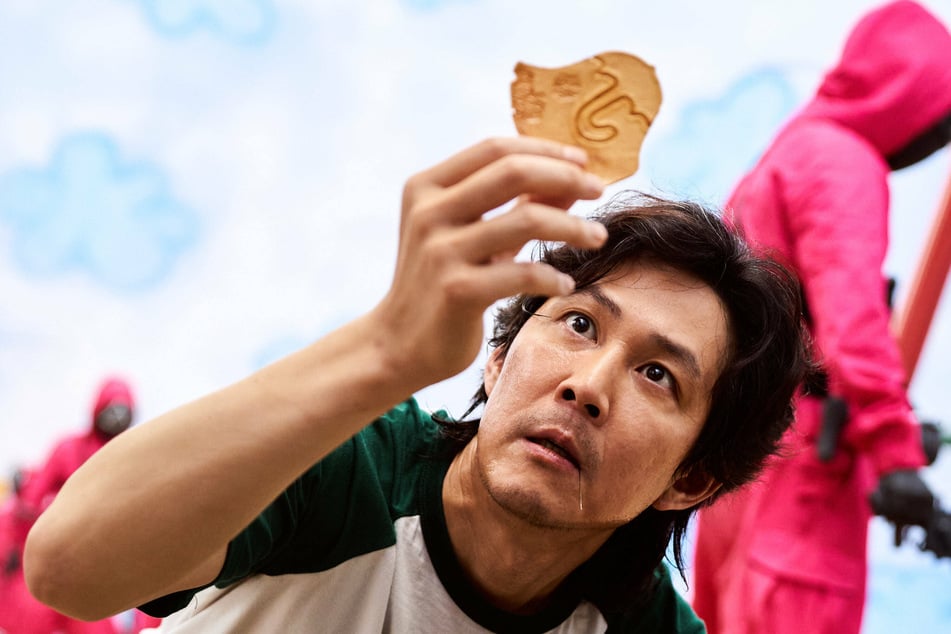 Actor Lee Jung-jae stars as one of hundreds of cash-strapped players in Squid Game who accept a strange invitation to compete in children's games for a tempting prize with deadly high stakes.