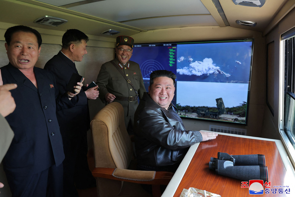 This picture taken on May 17, 2024 and released from North Korea's official Korean Central News Agency (KCNA) on May 18, 2024 shows North Korean leader Kim Jong Un inspecting a test fire of a tactical ballistic missile into which a new autonomous navigation system at an undisclosed location in North Korea.