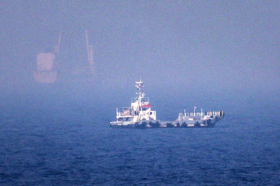 Ships sail near the Strait of Hormuz off the eastern coast of the United Arab Emirates at Khor Fakkan on July 13, 2026.