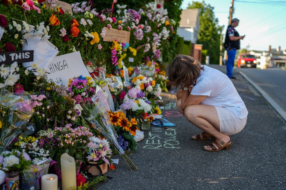 A woman crouches and mourns at a memorial for Joan Sebastian Durán Guerrero, who was fatally shot by a US Immigration and Customs Enforcement officer on Monday.