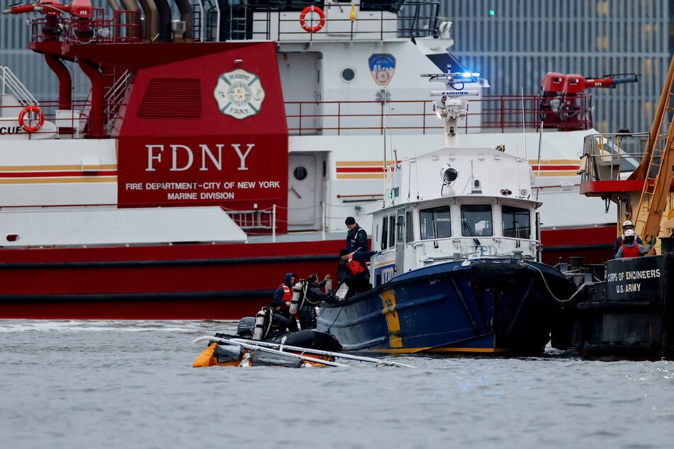NYPD members respond at the scene of a helicopter crash on the Hudson River near lower Manhattan in New York.