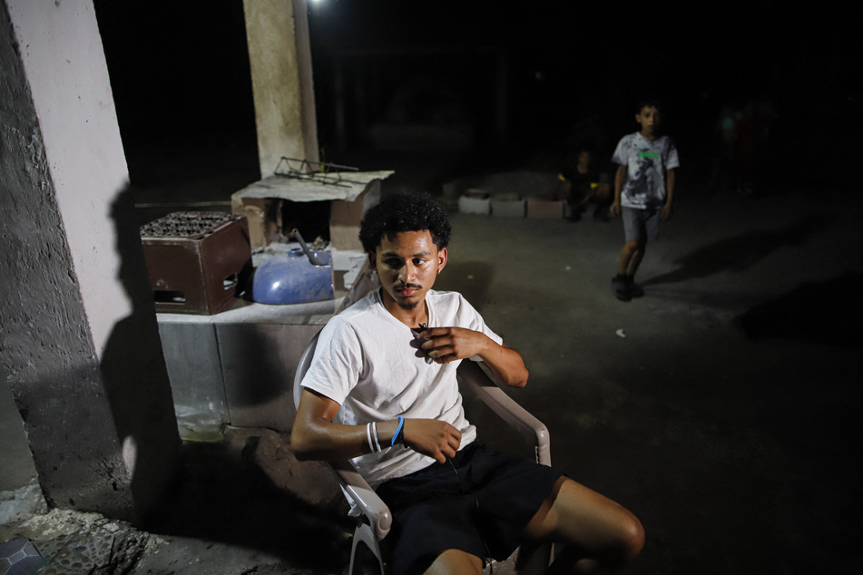 Emerson Colindres spends time with his family at their home in Marcovia, Honduras, on June 24, 2025.