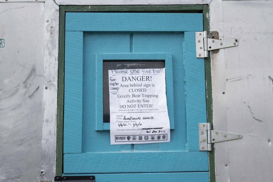 A flier posted on a small cabin warns campers about grizzly bear activity in the town of Ovando.
