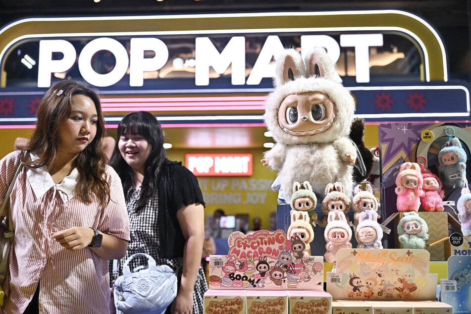 People look at collectible designer art toy Labubu at a Pop Mart pop-up store in Siam Center shopping mall in Bangkok on May 6, 2025.