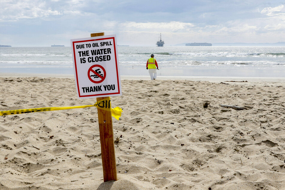 Environmental volunteers continue to clean up oil and residue that has washed ashore at Bolsa Chica State Beach and the Bolsa Chica Wetlands.