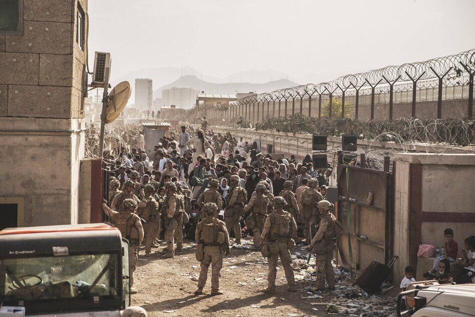 Kabul airport still full of crowds hoping for evacuation as Biden refuses to extend deadline