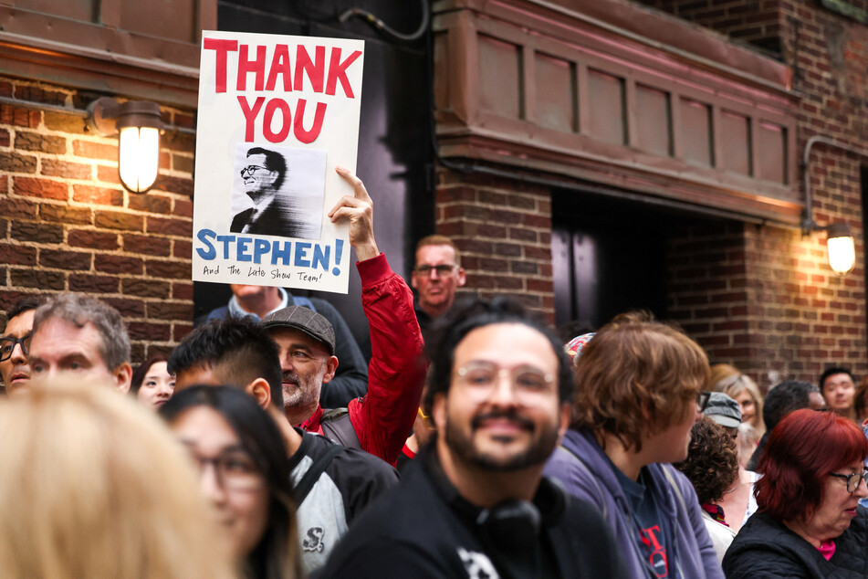 People wait in hopes of seeing Stephen Colbert outside the Ed Sullivan Theater after the taping of the final episode of The Late Show on May 21, 2026.
