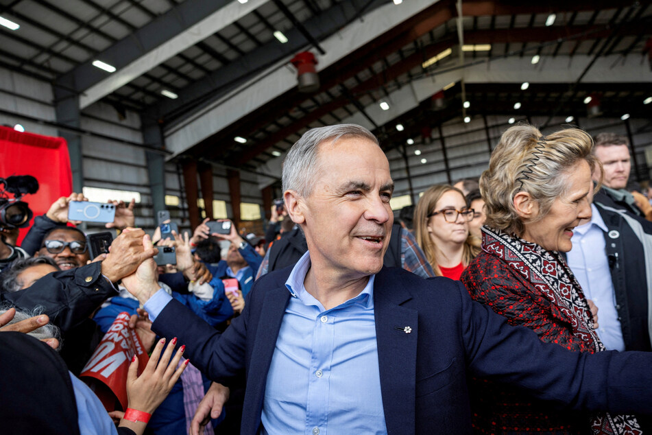 Canada's Prime Minister Mark Carney interacts with supporters at a rally in a Pearson International Airport hangar during his Liberal Party election campaign tour in Mississauga on April 26, 2025.