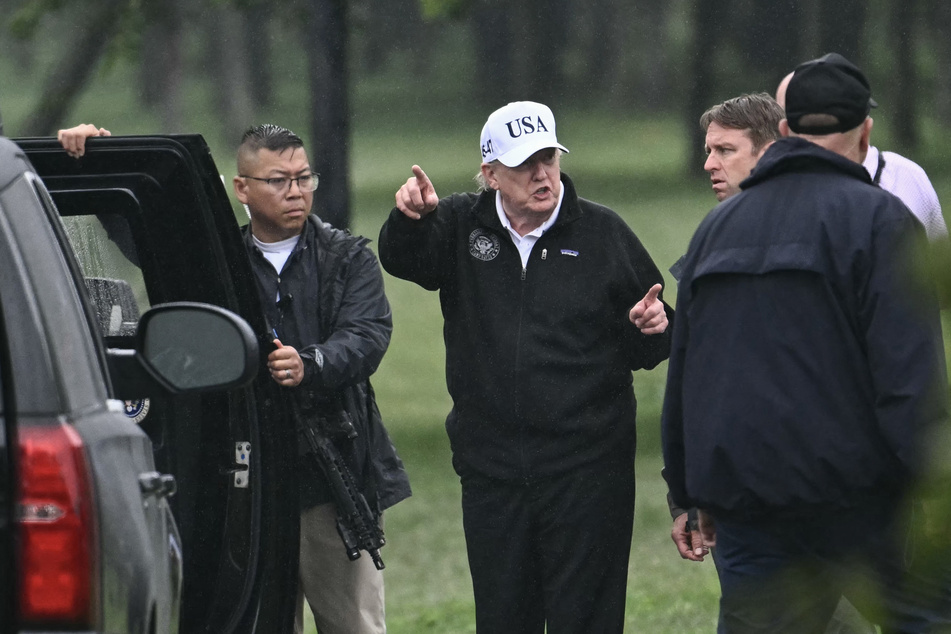 President Donald Trump gestures as he stands near his motorcade after making a visit to East Potomac Golf Links in Washington DC on June 28, 2026.