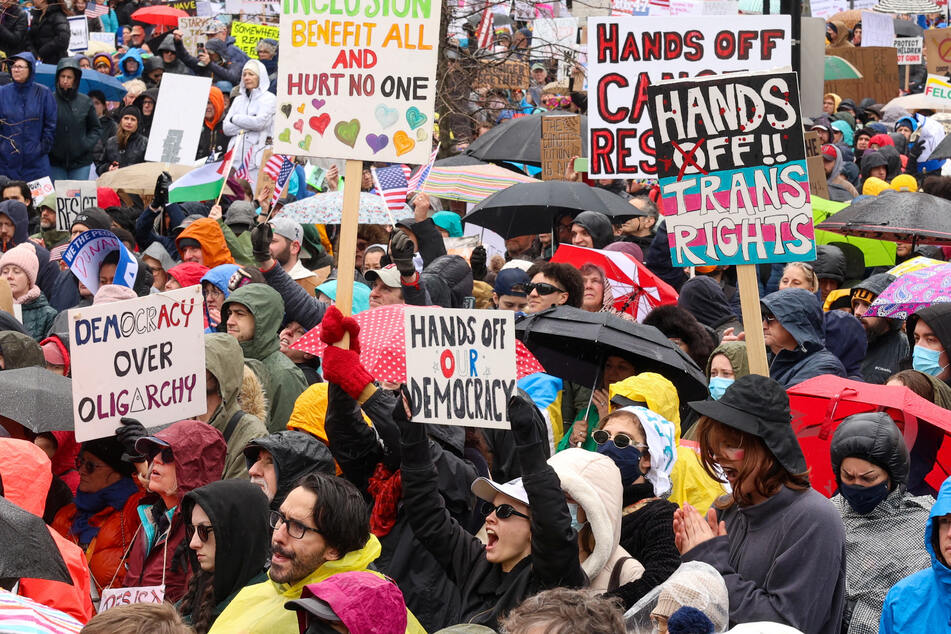 People take part in the nationwide Hands Off anti-Trump protests in Boston, Massachusetts.