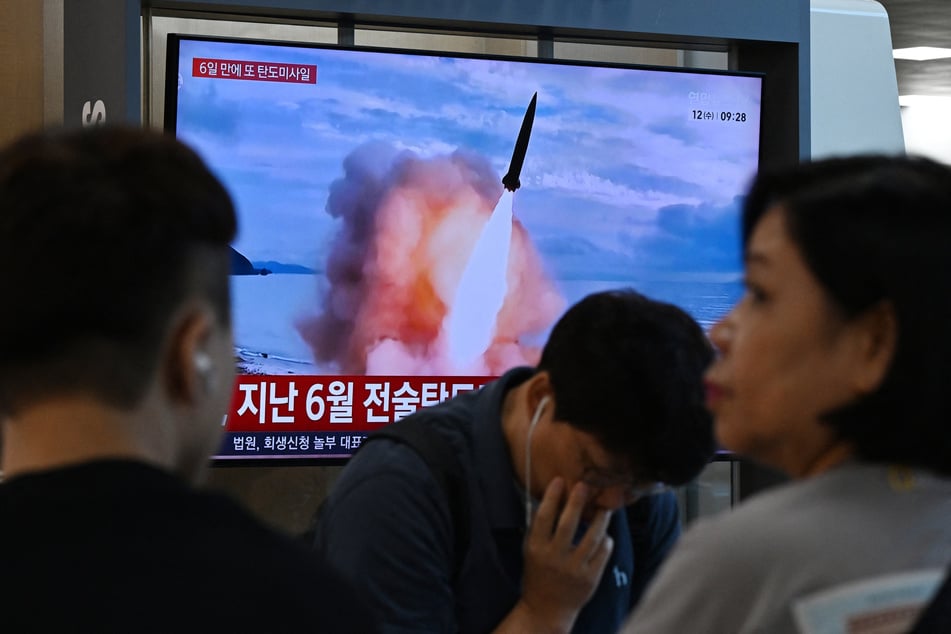 News coverage showing file footage of a North Korean missile launch is seen on a screen at Seoul Station in South Korea on August 12, 2026.