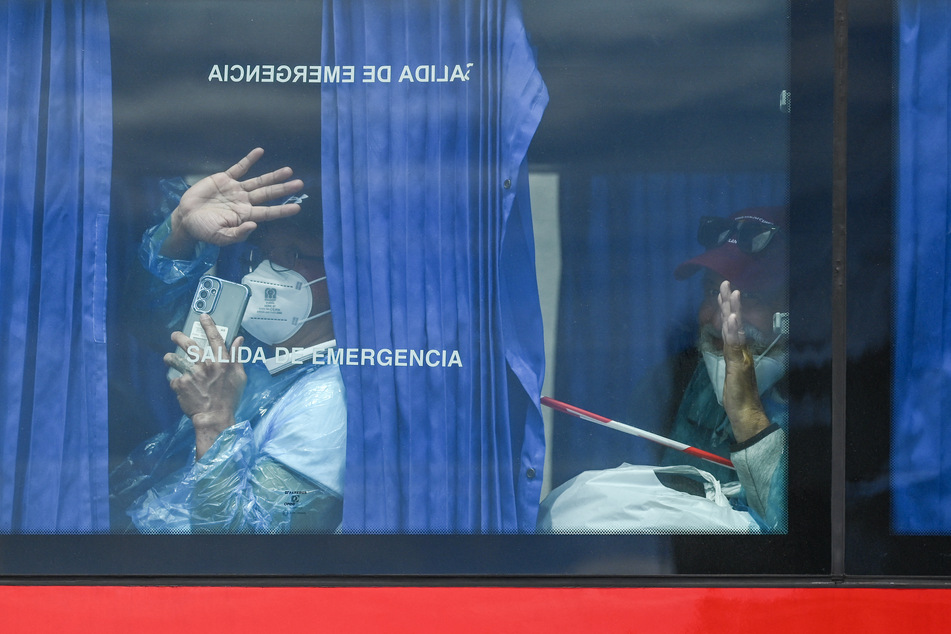 Passengers from the MV Hondius on their way to repatriation flights.
