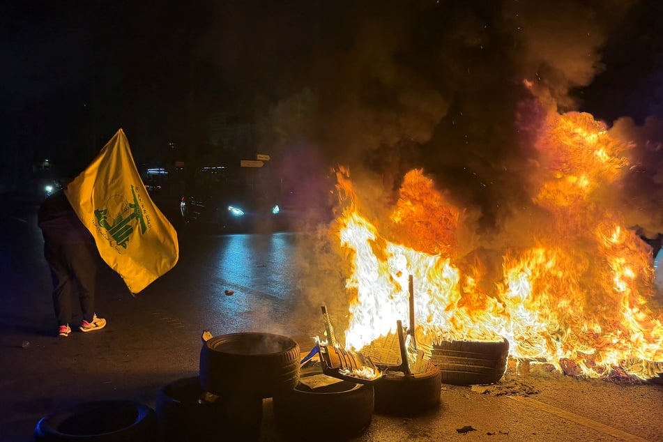 Hezbollah supporters block the old airport road in the southern suburbs of Beirut, with burning tires, to protest against the trilateral agreement that was signed between the US, Israel, and Lebanon on Saturday.
