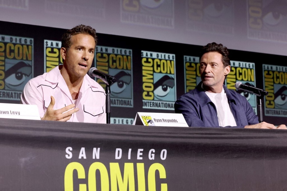 Ryan Reynolds (l.) and Hugh Jackman speak onstage during Marvel Studios: The Ultimate Deadpool & Wolverine Celebration of Life at Comic-Con in San Diego, California.