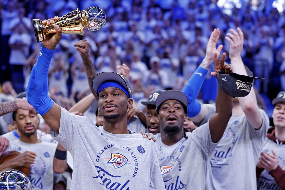 Oklahoma City Thunder guard Shai Gilgeous-Alexander celebrates with the Magic Johnson West Conference Finals MVP trophy after defeating the Minnesota Timberwolves in Game Five at Paycom Center.