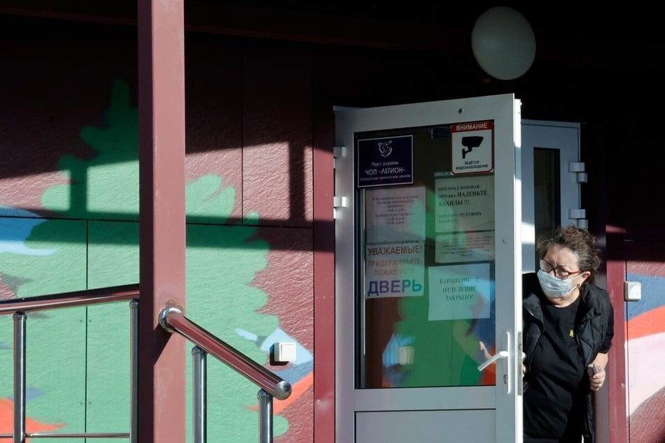 A security person looks out from the door of an infectious diseases hospital in Shelekhov, Russia. Doomsday preppers are pushing the necessity of buying a health kit amid fear of a plague outbreak.