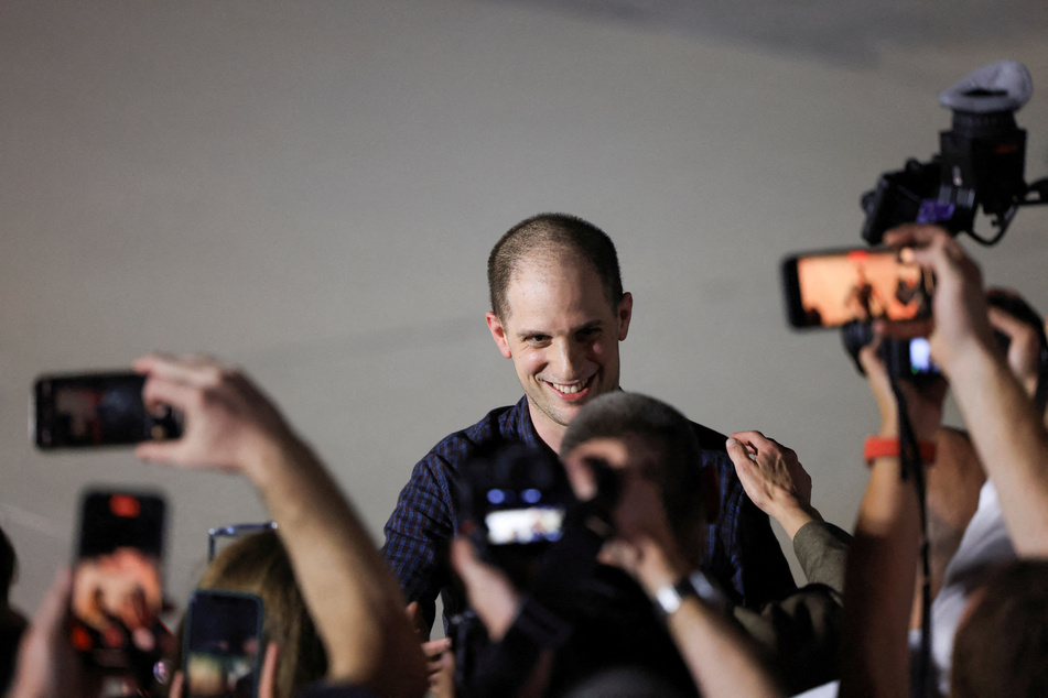Evan Gershkovich, who was released from detention in Russia, reacts after disembarking from a plane at Joint Base Andrews in Maryland.