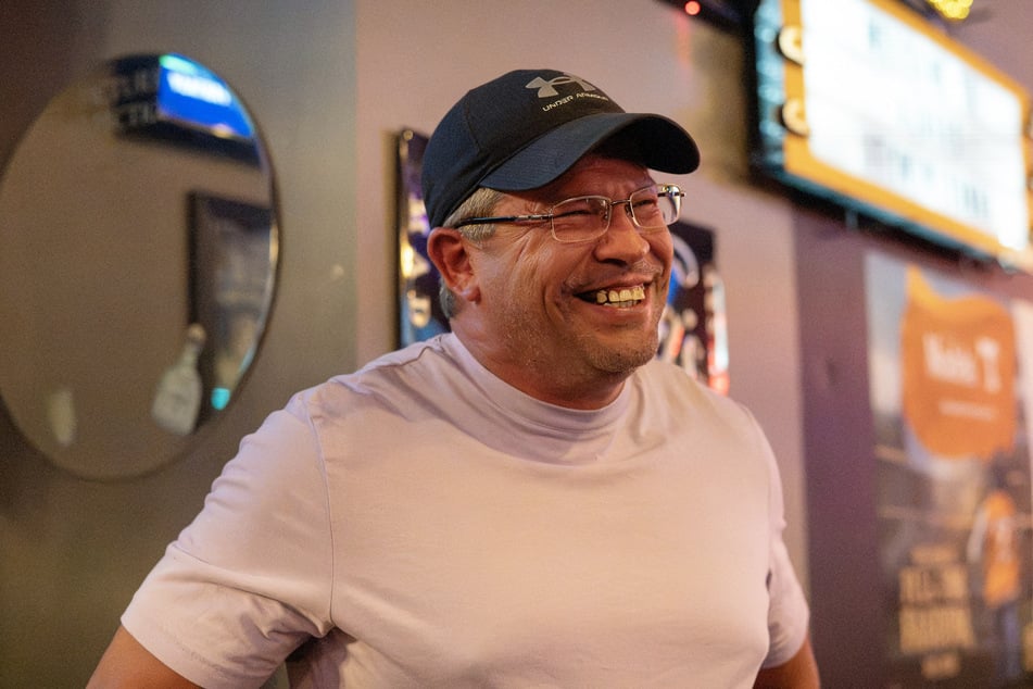 Brent Allen, a cousin of Dolly Parton, smiles while talking to a reporter at a bar in Sevierville, Tennessee, on August 25, 2026.