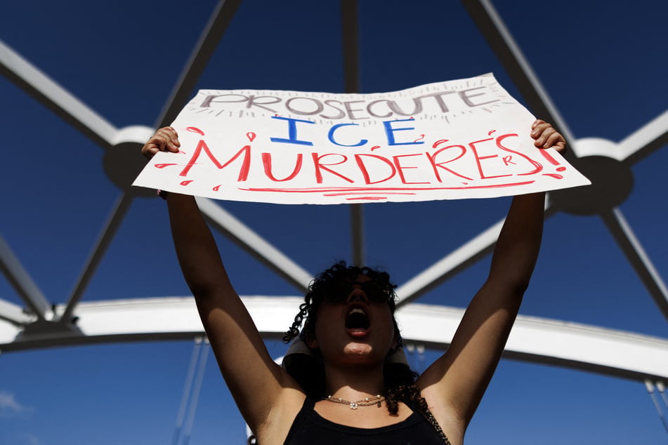 A demonstrator holds a sign reading "Prosecute ICE Murderers" as people gather in Houston, Texas, on July 19, 2026, to protest the killing of Lorenzo Salgado Araujo.