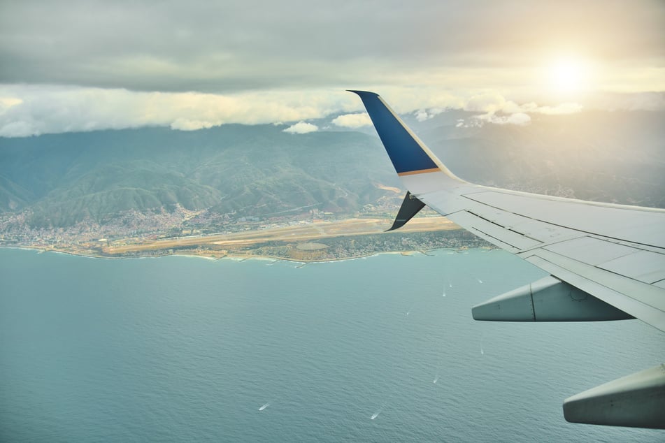The Simon Bolivar International Airport in Maiquetia, Venezuela, is visible from the window of a plane.