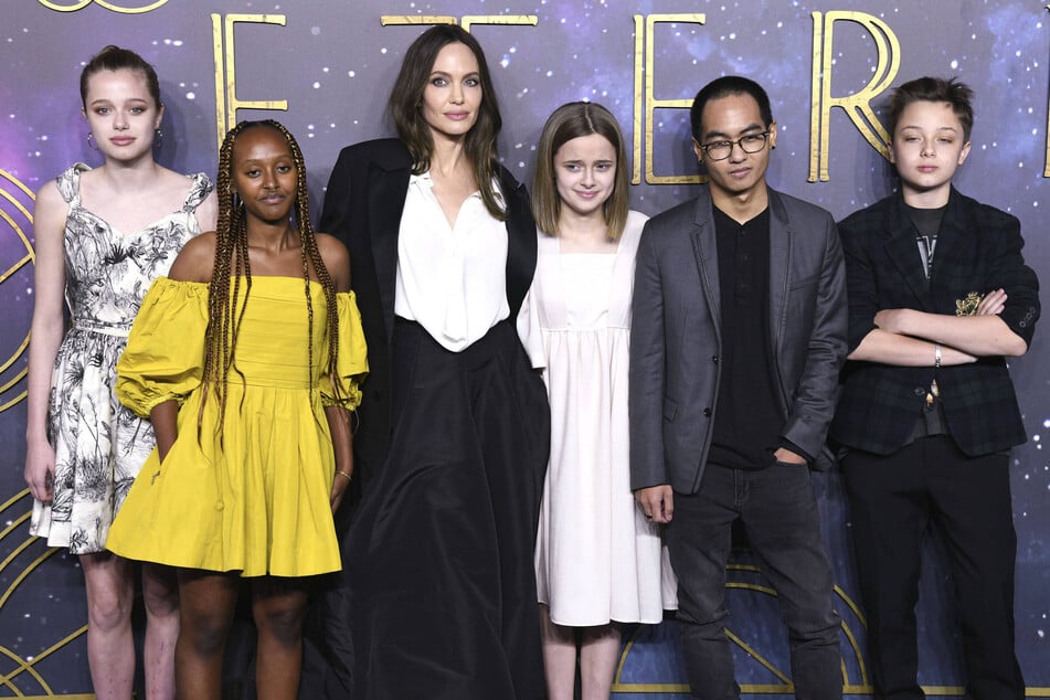 Angelina Jolie (center l) said she's "proud" of her six kids' individuality after four of them filed to drop their dad's last name. The Oscar winner shares all of her children with actor Brad Pitt.