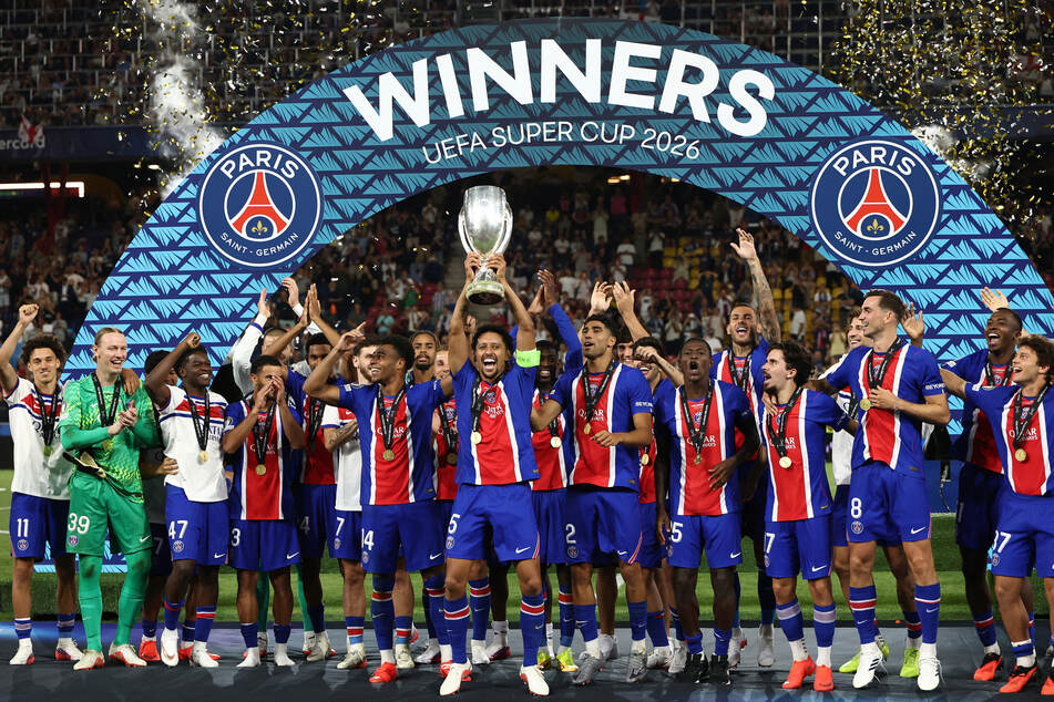 Paris Saint-Germain players celebrate with the trophy after winning the UEFA Supercup soccer match against Europa League winners Aston Villa in Salzburg, Austria, on August 12, 2026.