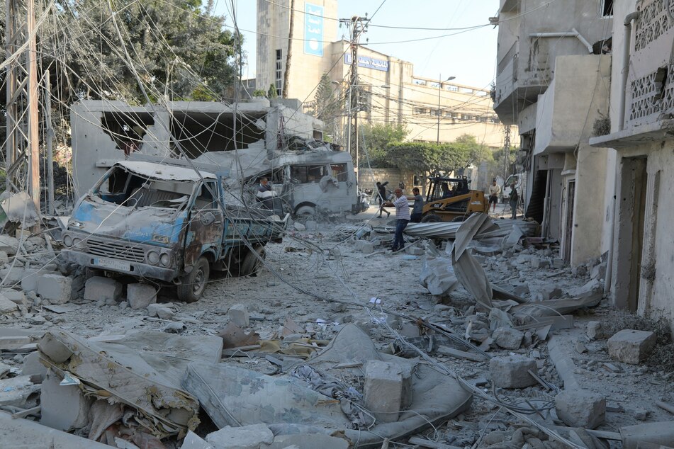 Workers clean the debris following Israeli airstrikes that hit the previous day, near the archaeological site of the Roman hippodrome in the southern Lebanese city of Tyre, on June 8, 2026.