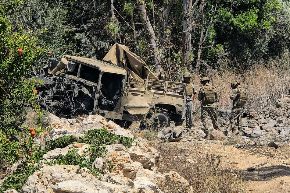Lebanese army soldiers inspect the site of an explosion that targeted their vehicle in the southern Lebanese area of al Mansouri near Tyre on Saturday.