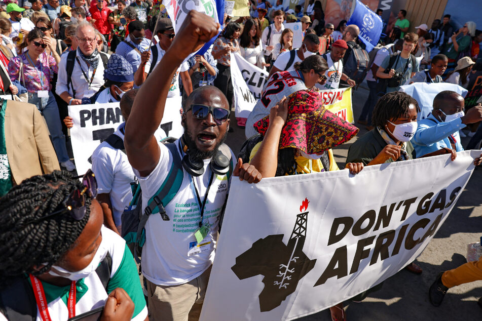 Climate activists held banners as they protested during the COP27 climate conference.