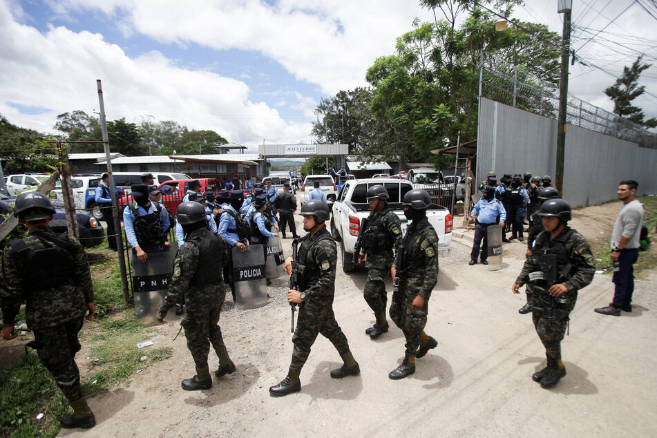 Heavily armed soldiers and police arrived to guard the prison, while teams of firefighters were present to put out the devastating cell fire.