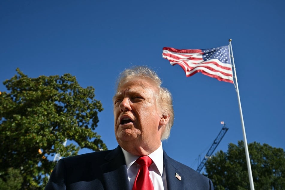 Trump brushes off speech interrupters as "paid protesters" at Texas rally 