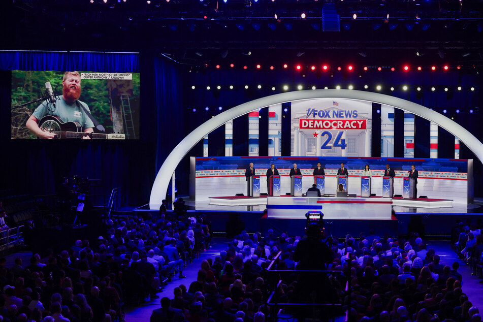 Republican presidential candidates watch and listen as a video is shown of Oliver Anthony singing his song Rich Men North of Richmond at the first 2024 GOP primary debate.