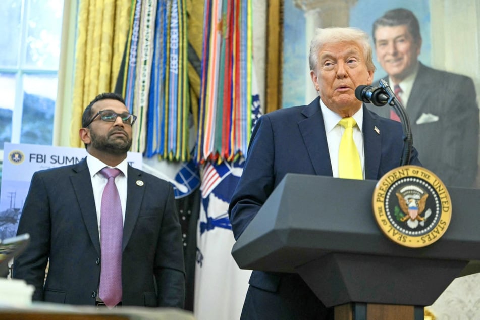President Donald Trump (r.) speaks to the press as the Federal Bureau of Investigation Director Kash Patel listens in the Oval Office at the White House, in Washington, DC, October 15, 2025.