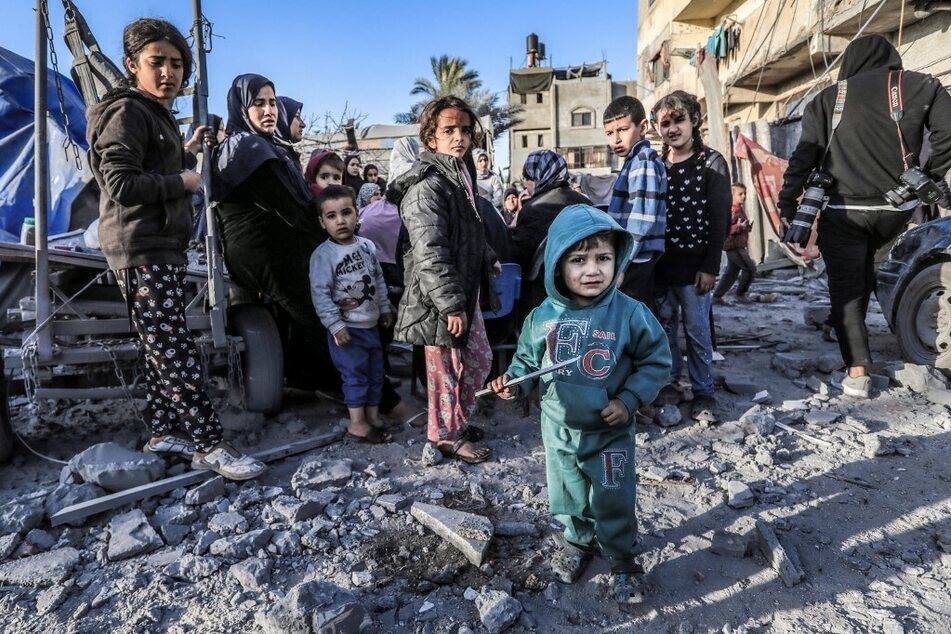 Children stand amid the rubble of a mosque and makeshift shelters that were destroyed in Israeli strikes in Deir al-Balah in central Gaza.