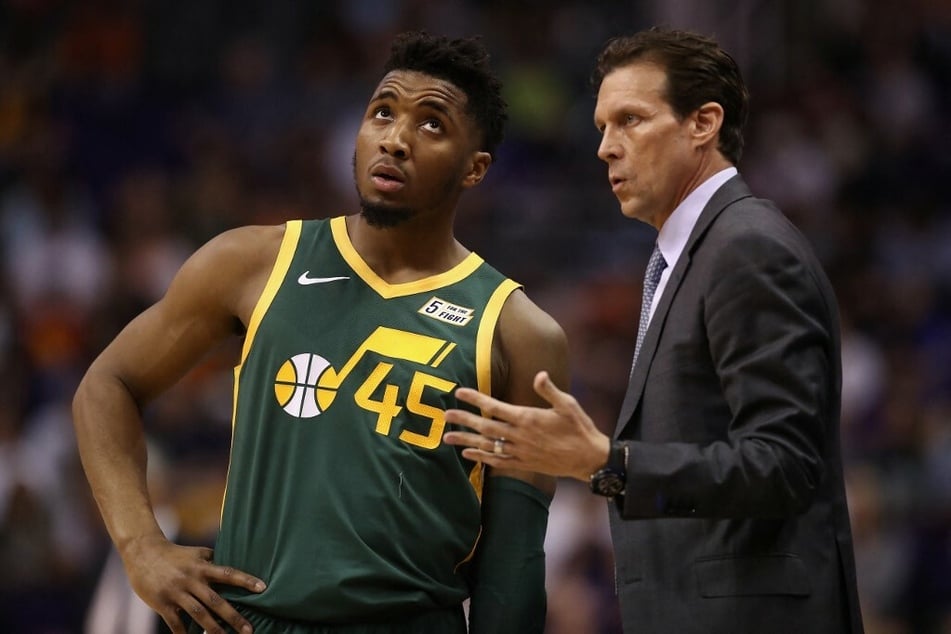 Head coach Quin Snyder giving advice Donovan Mitchell during a game against the Phoenix Suns.