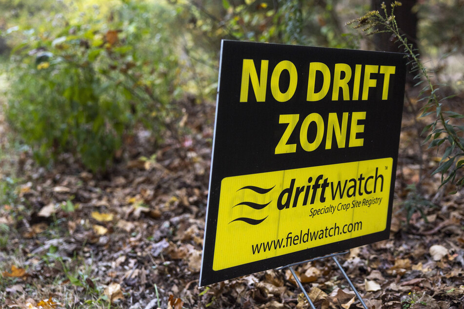 A resident of Venedy, Illinois, places a sign near their driveway to speak against chemical drift damage.