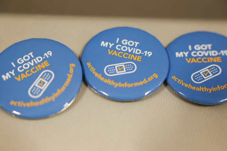 Covid-19 vaccination awareness pins are displayed during an immunization event at the LA Care and Blue Shield of California Promise Health Plan Community Resource Center on October 24, 2025.