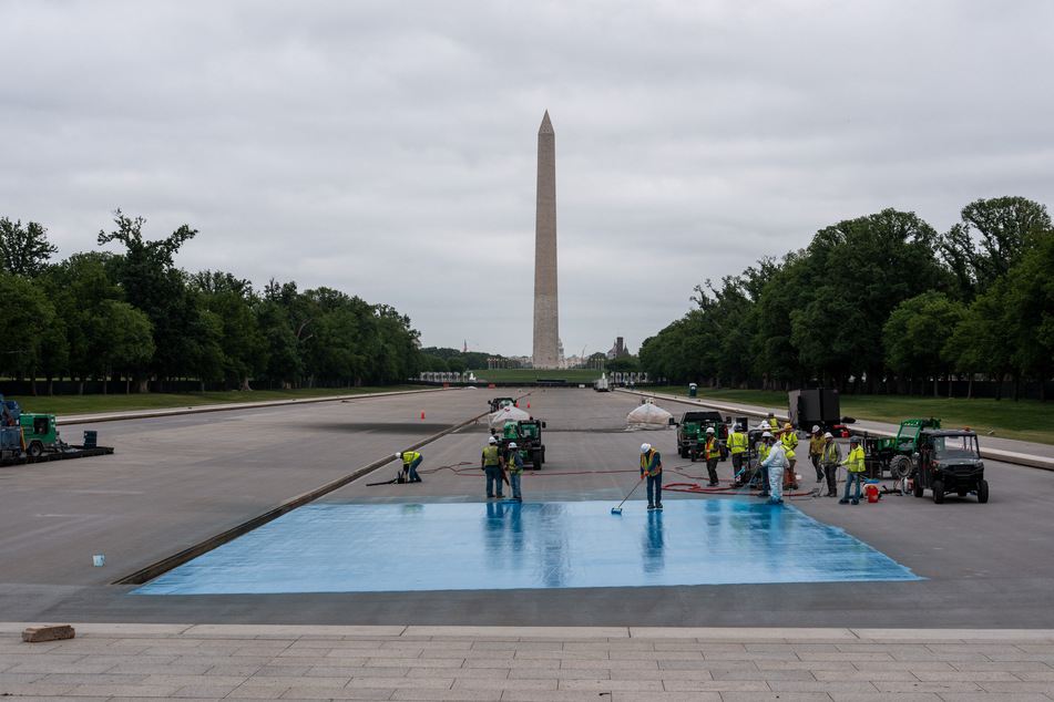 Crews spray a new blue coating on the Lincoln Memorial Reflecting Pool on April 25, 2026 in Washington, DC.
