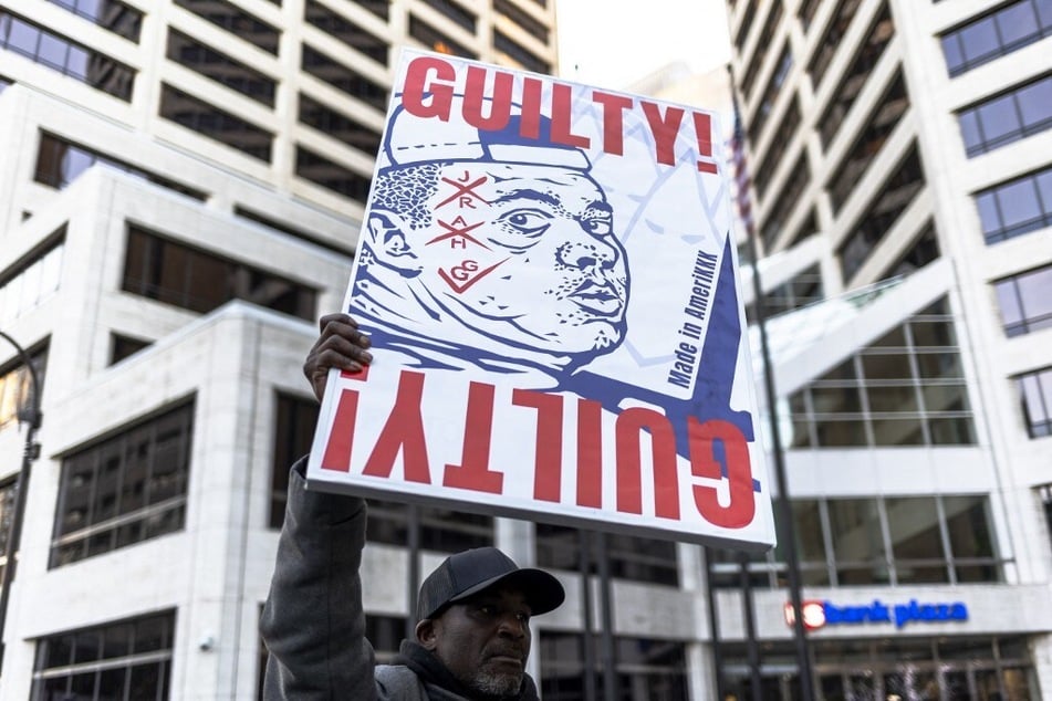A protester holds a sign calling for the conviction of Kyle Rittenhouse for his August 2020 shootings in Kenosha, Wisconsin.