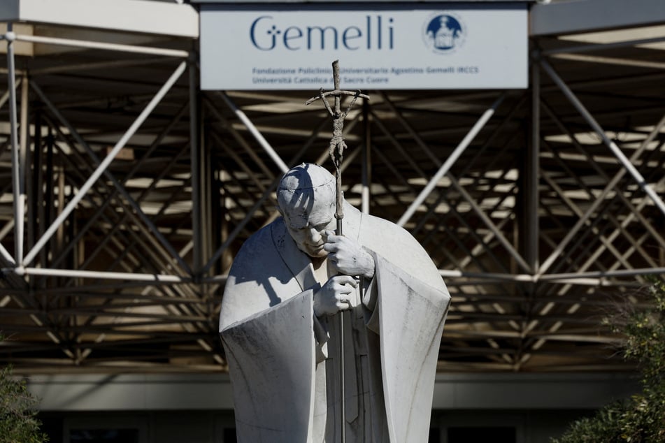 A statue of the late Pope John Paul II is pictured outside Gemelli Hospital after the Vatican said Pope Leo had been diagnosed with lung cancer, on October 14, 2026.
