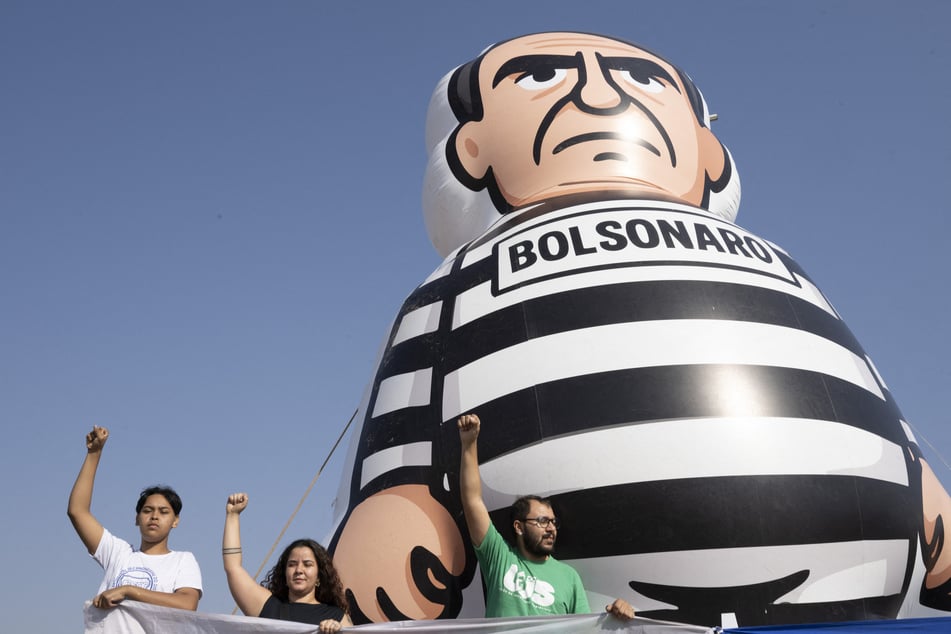 Students demonstrate next to a giant inflatable of former Brazilian President Jair Bolsonaro dressed as prisoner in Brasilia on September 12, 2025 – one day after Brazil's Supreme Court sentenced him to 27 years for coup plotting.